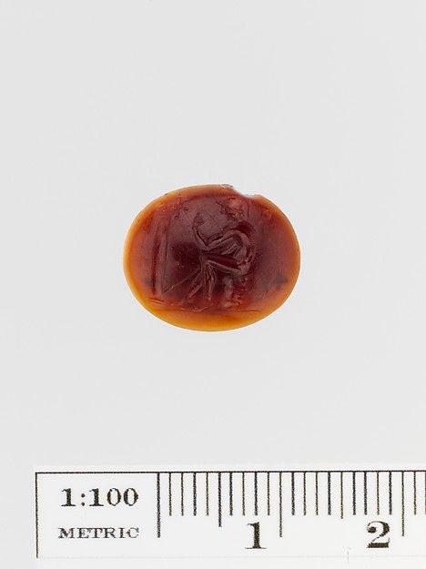 Tiny engraved Roman sard ring stone showing a seated figure, catalogued by the Metropolitan Museum under Oedipus and the Sphinx